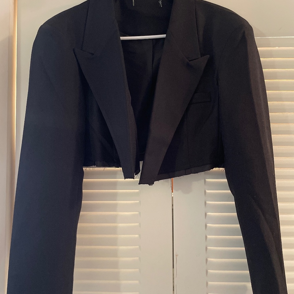 Cropped black jacket with distressed hems  on sleeve and bottom